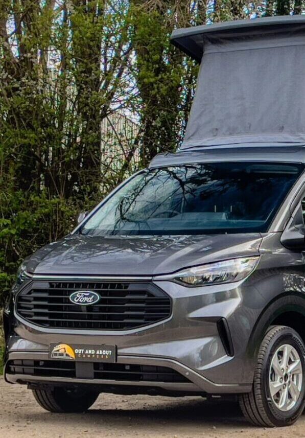Grey Ford Transit with pop-top roof