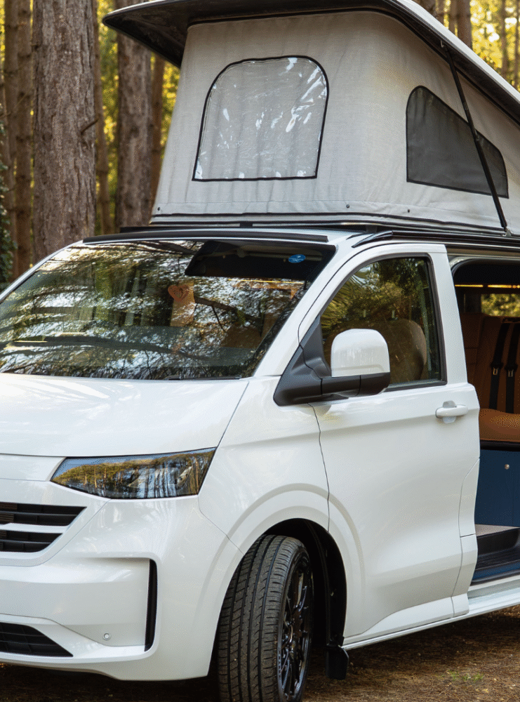 White T7 which has been converted into a campervan with a pop top and kitchen area