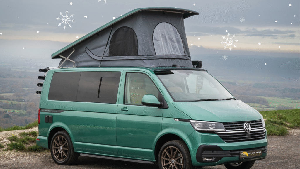 Green camper against a backdrop of the downs with superimposed snow